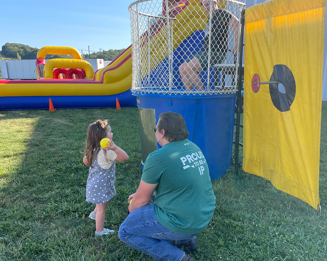 A child throws a ball at a dunk tank on Atglen, PA's Friends & Family Day.