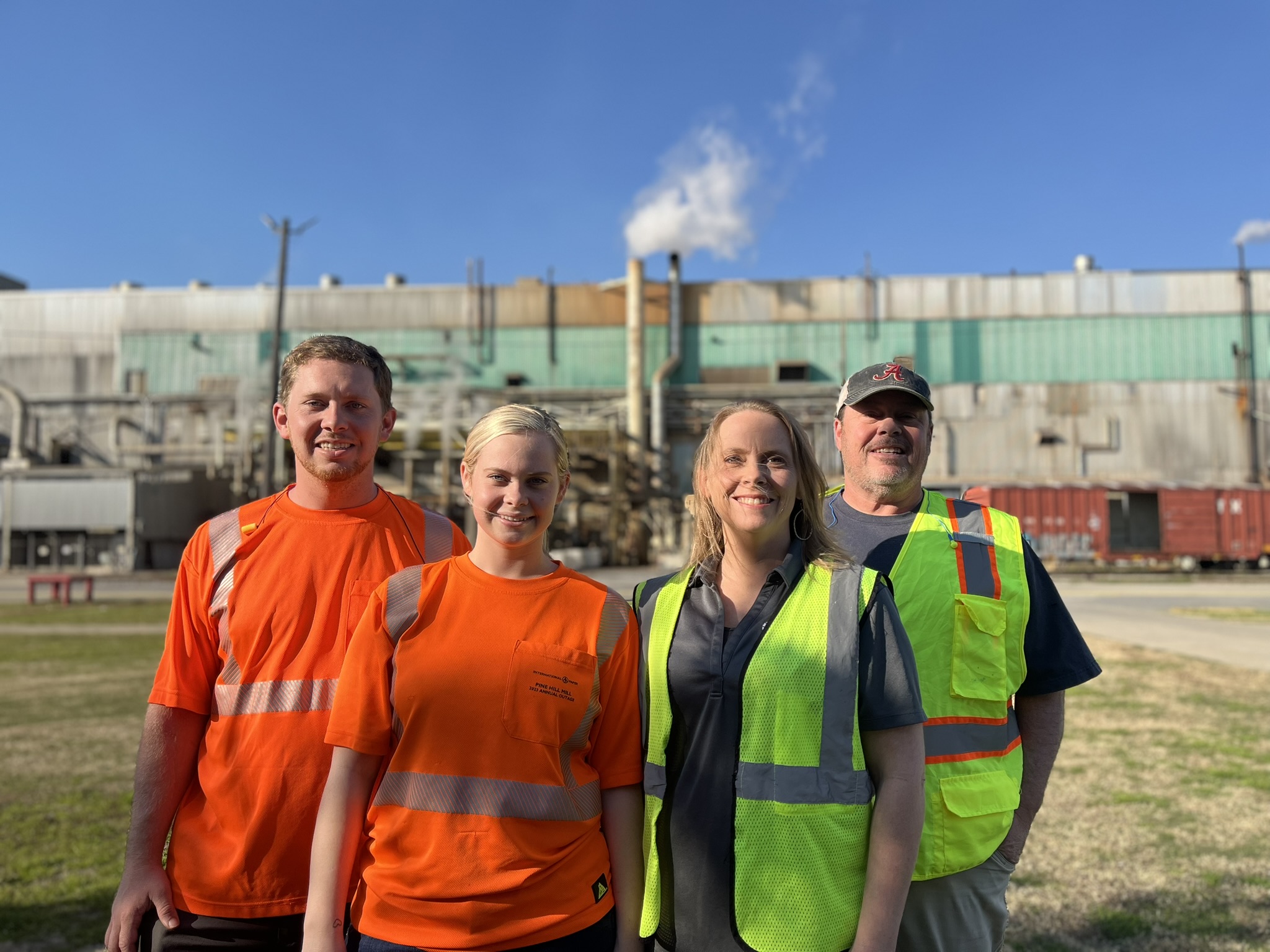 Boyette family members standing in front of IP facility