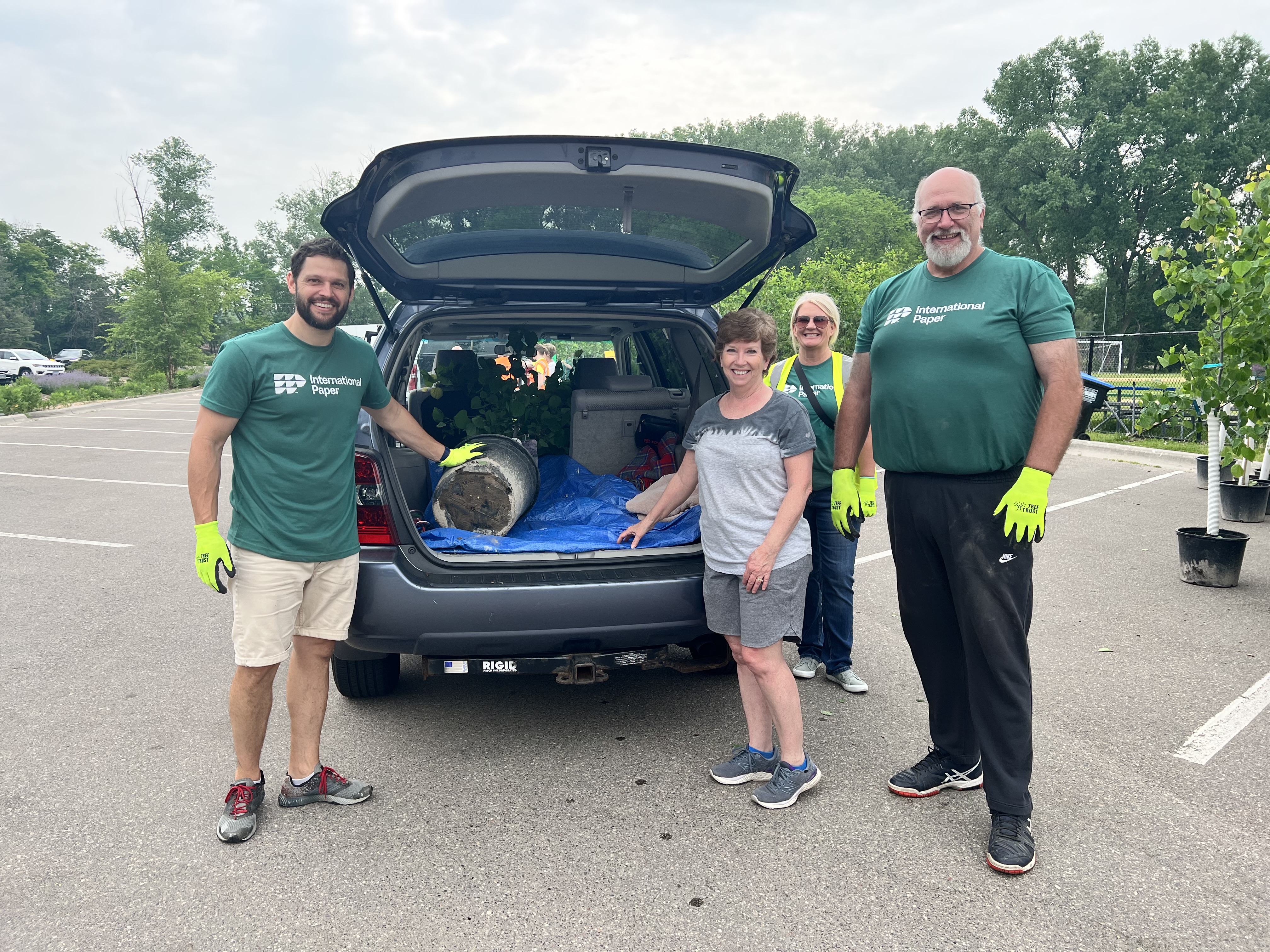 International Paper employee wearing a "Proud to be IP" shirt while supporting a community engagement event for the Arbor Day Foundation