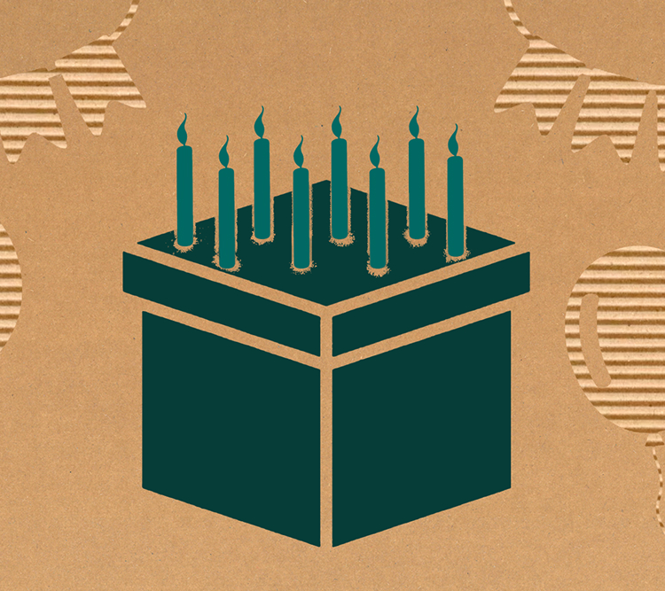 cardboard box with candles on top, simulating a birthday cake