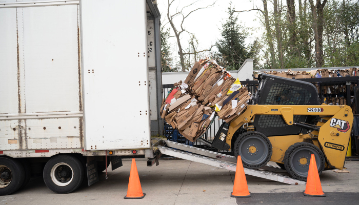 forklift moving a stack of bales into a trailer truck