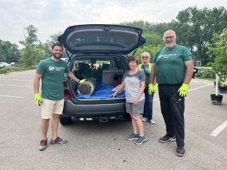 International Paper employee wearing a "Proud to be IP" shirt while supporting a community engagement event for the Arbor Day Foundation