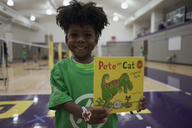 little boy holding a book