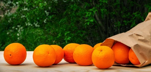 fruit arranged around a paper bag