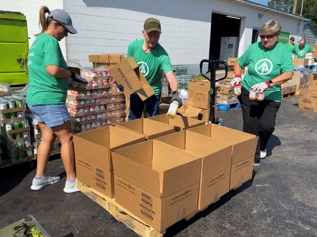 IP volunteers pack boxes of food for the Food Bank of Central and Eastern North Carolina.