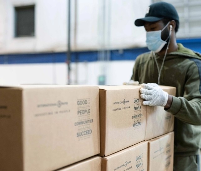 A volunteer stacks IP community engagement boxes