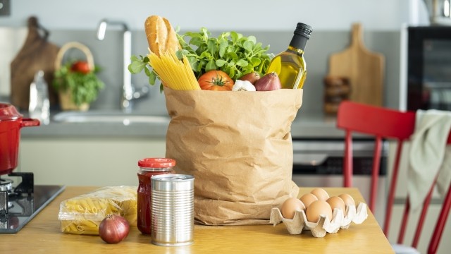 A kraft paper carry sack contains grocery items