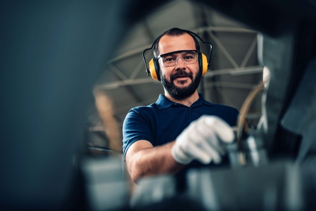 A man works in a European manufacturing facility