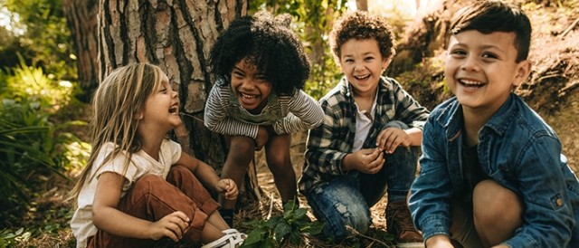 Children laughing under a tree