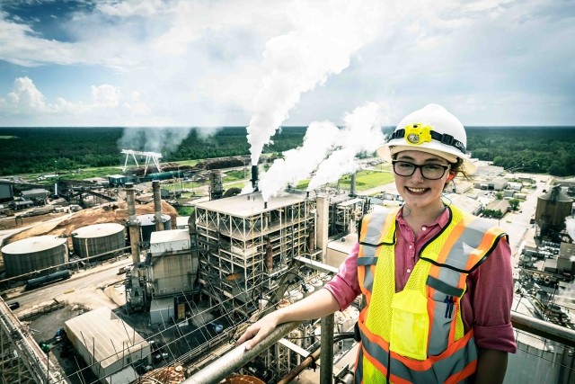 A woman engineer has an aerial view of a paper mill