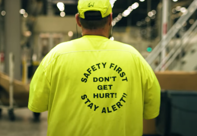 An IP employee wears a bright yellow safety first t-shirt