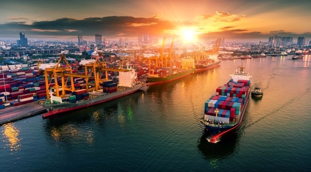 A shipping port with cargo ship in foreground