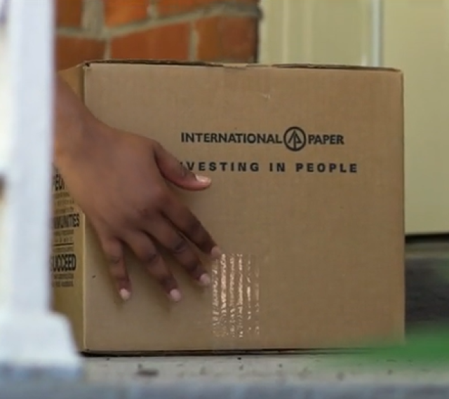 A volunteer drops off an IP community engagement box