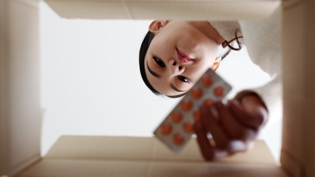 woman looking into a box