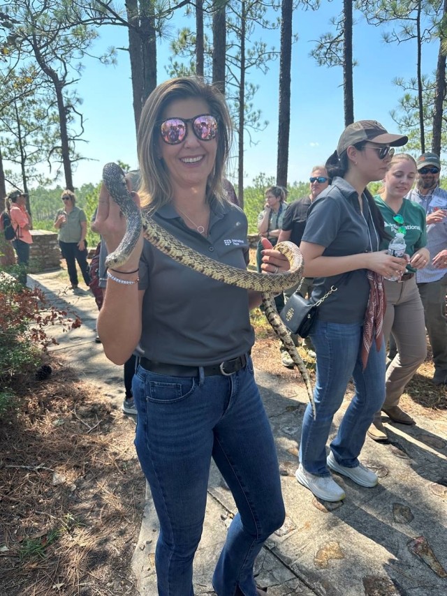 An IP employee holds a Louisiana pine snake