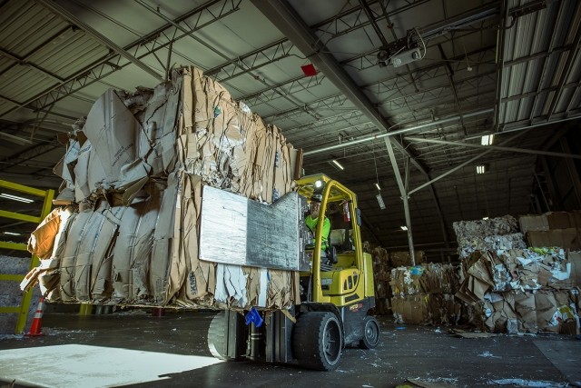 wideshow of a forklift lifting bales