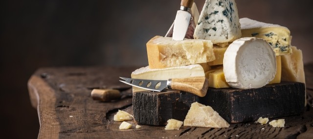 A selection of cheese on a wooden table