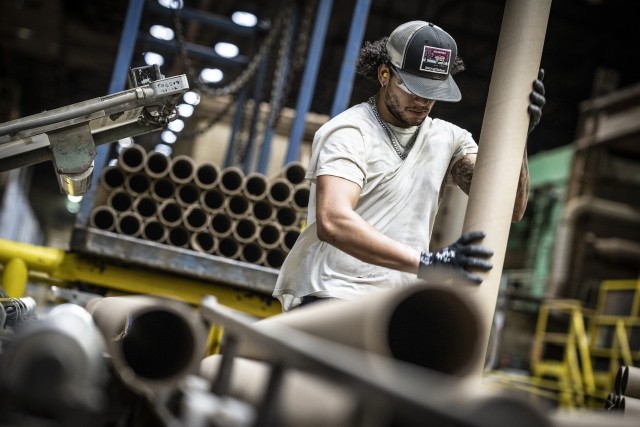 a man loads corrugated cylinders