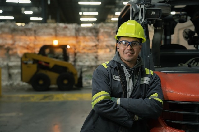 man leaning on a forklift with arms crossed